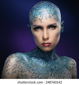 Bald girl with colorful make-up art. Concept - The Snow Queen. Face-art. Bodypainting.