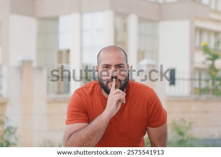 Bald indian Man Shushing in the Camera