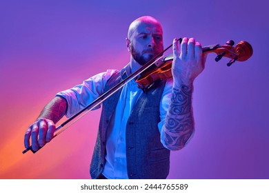 Bald man in classical clothes, with tattoo, musician playing violin against gradient purple background in neon light. Concept of music, talent show, performance, concert, festival, instruments - Powered by Shutterstock