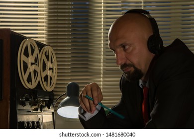 Bald Man In Headphones Listening To Music, Listening And Recording Conversations, Watching And Controlling People, The Average Plan