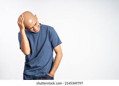 bald man laughing holding his bald head
