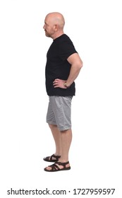 Bald Man In Profile With Shirt Shorts And Sandals, Hand On Hip