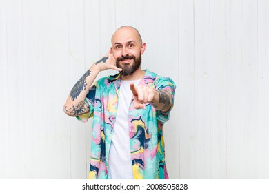 Bald Man Smiling Cheerfully And Pointing To Camera While Making A Call You Later Gesture, Talking On Phone