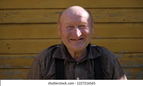 Bald Old Countryside Man With No Teeth Smiling To Camera, Close Up