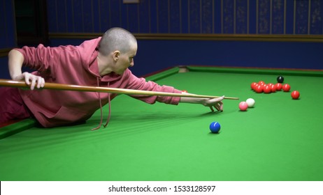 Bald Woman Plays Billiards. Snooker. Game Of Billiards In A Billiard Club