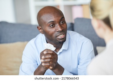 Bald Young Black Man Holding Napkin In Hands And Talking To Therapist While Looking For Solution