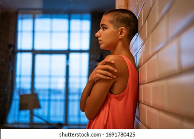 Bald young woman looks away, loneliness and depression. - Powered by Shutterstock