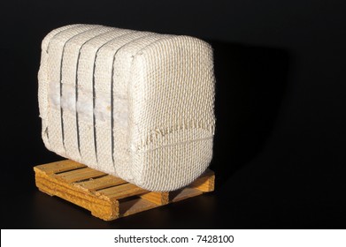 A Bale Of Raw Cotton On A Pallet.