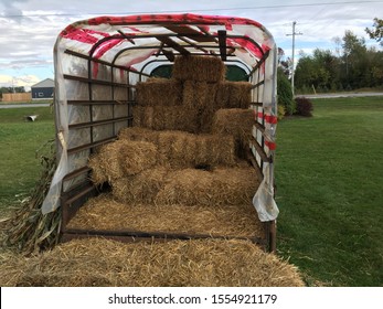 Bales Of Hay Sit On A Truck Bed. 