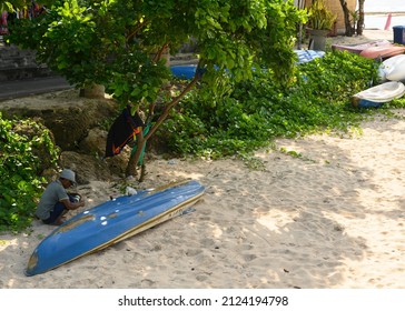 Bali, Indonesia - 02 01 2022 : An Old Man Starring At His Canoe For Kayaking That Are Empty Of Visitors Due To The Pandemic.