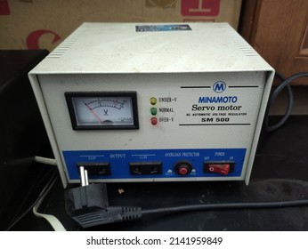 Bali, Indonesia - April 01, 2022: Dirty voltage stabilizer on office. The basic purpose of a Voltage Stabilizer is to protect the electrical or electronic gadgets.