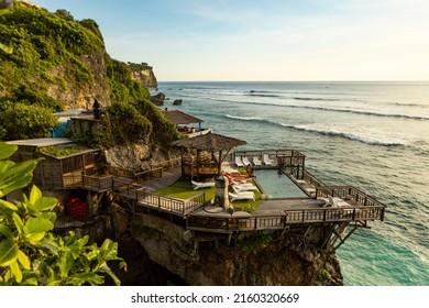 BALI, INDONESIA - April 2022: Villa with swimming pool on the cliff in Uluwatu beach, Bali, Indonesia