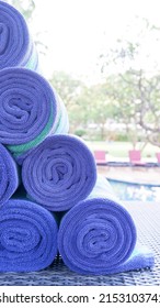 Bali, Indonesia, February 1, 2022. Rolled towels at the edge of the pool used to dry the body after swimming. Towel is a piece of cloth or paper that can absorb liquid and is used to wipe or dry.