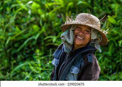 Bali, Indonesia - January, 12 - 2014 : Balinese farmer women smiling with a straw hat on her head
