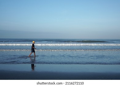 Bali, Indonesia. January, 16 2022. Middle Aged Man Walking Alone On Kuta Beach, Bali.                  