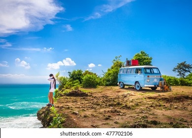 BALI, INDONESIA, Jimbaran beach - May 1, Young beauty sexy girl enjoy vacation on tropical island on the background vintage car van bus volkswagen with suitcase, beutiful nature with sea ocean water