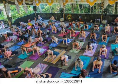 Bali, Indonesia - March 27, 2019: Large Kundalini Yoga Class Practicing Poses During Festival