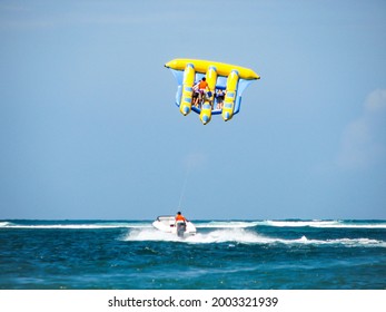 Bali, Indonesia - May 2008: Flying Fish Water Sport Activity In Tanjung Benoa. Popular Tourist Attraction. Clear Blue Sky With Horizon In Background.