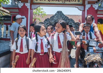 BALI, INDONESIA - NOVEMBER 3RD 2014 : Balinese Kids In School Uniform Just Finish And Out From School. Parents Pick Them Up With Motorcycle.