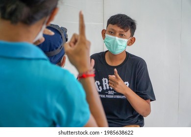 BALI,INDONESIA-MAY 28 2021: An ENT doctor is examining the ears, nose and throat of a pediatric patient. During the COVID-19 pandemic, ENT examinations are very risky 