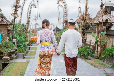 Balinese Couple Portrait From Behind While Walking In Penglipuran Heritage Village