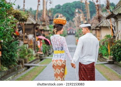 Balinese Couple Portrait From Behind While Walking In Penglipuran Heritage Village