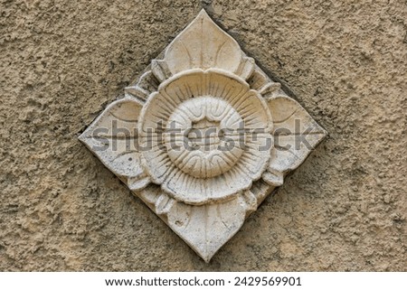 Balinese stone carved flower pattern background on cement wall

