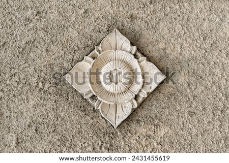Balinese stone carved flower pattern background on cement wall