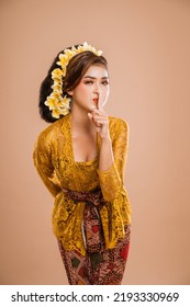 Balinese Woman With Kebaya Showing Be Quiet Gesture. Concept Of Bali Day Of Silence