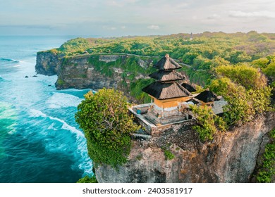 Bali's Most Iconic Landmark and popular tourist attraction Uluwatu Temple one of six key Bali temple perched on top mountain cliff on background amazi