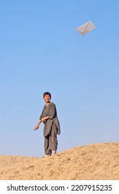 BALKH, AFGHANISTAN - JULY 21 2009: Kid Playing With Kite In The Desert