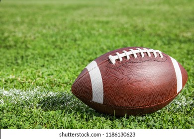 Ball For American Football On Fresh Green Field Grass