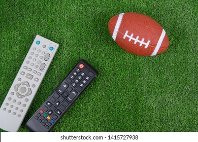 Ball For Baseball And Remotes From The TV On The Green Grass, Watch The Match, Live Broadcast, Championship. Fan. American Football