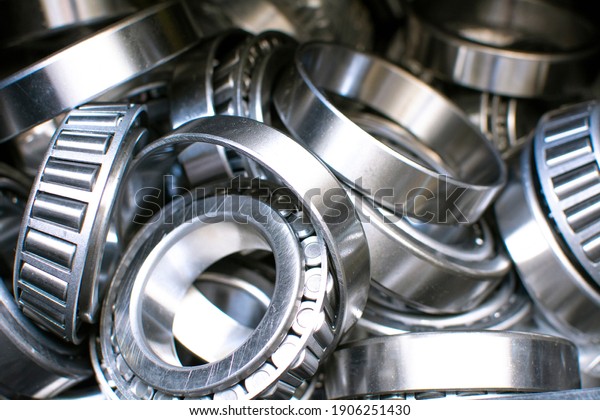 Ball\
bearings. Industrial steel spare parts close up background.  \
Machinery, engine mechanism, engineering\
concept.