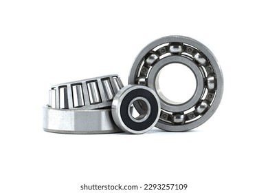 Ball bearings and tapered roller bearing isolated on white background. Car bearings, auto parts, automobile components for the engine and chassis suspension
