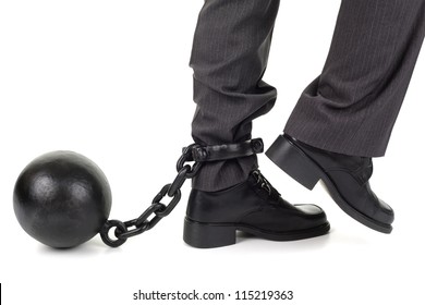 Ball and chain restraining a businessman as he tries to walk