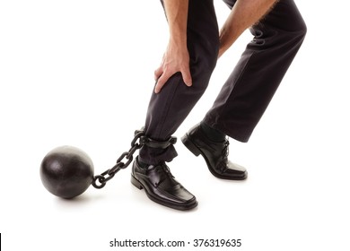 Ball And Chain Restraining A Businessman As He Tries To Walk Concept For Business Burden, Willpower And Determination