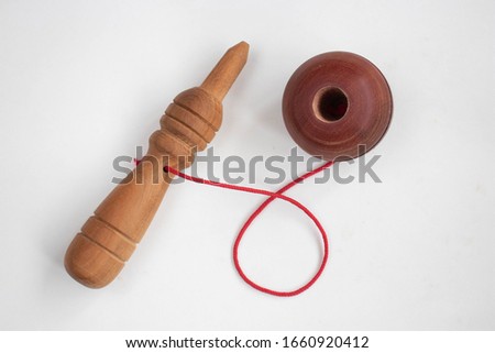 Ball in a cup toy on a white background