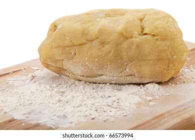 A Ball Of Dough Kneaded For A Cake On Wooden Board With Wheat Flour, Isolated On White