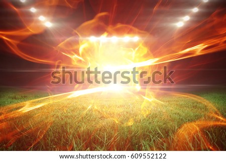Ball of fire against football pitch with bright lights 3d