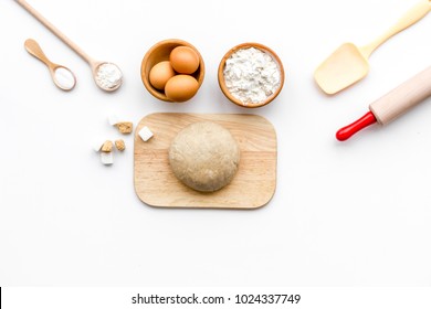 Ball Of Fresh Raw Dough Near Ingedients And Cookware On White Background Top View Copy Space