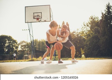 Ball For Girl. Couple Playing Basketball.