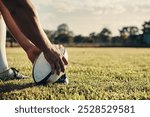 Ball, hands and rugby with people outdoor on field for competition, challenge or scoring closeup. Exercise, performance and sports training with player on grass for kick in game or match at stadium