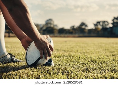 Ball, hands and rugby with people outdoor on field for competition, challenge or scoring closeup. Exercise, performance and sports training with player on grass for kick in game or match at stadium - Powered by Shutterstock