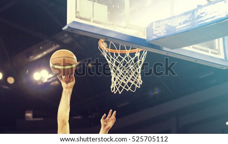 Ball in hoop at basketball game