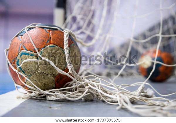 Ball on the\
floor at the goal, handball,\
futsal