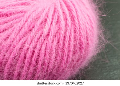 Ball Of Pink Angora Wool Against Black Background