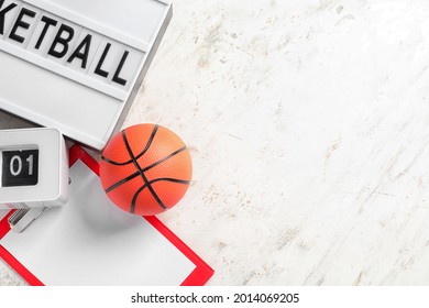 Ball For Playing Basketball Game With Alarm Clock And Clipboard On White Background