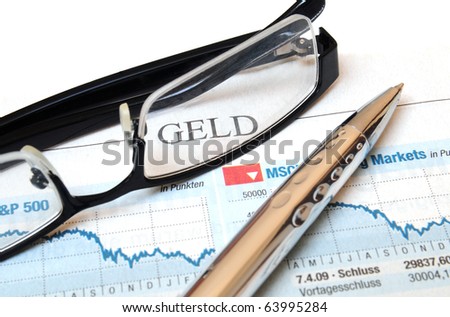 Ball point and glasses on top of a chart report