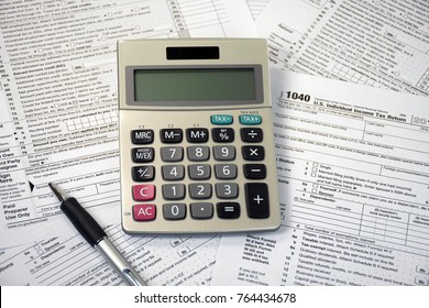 Ball Point Pen And Calculator On Federal 1040 Income Tax Form